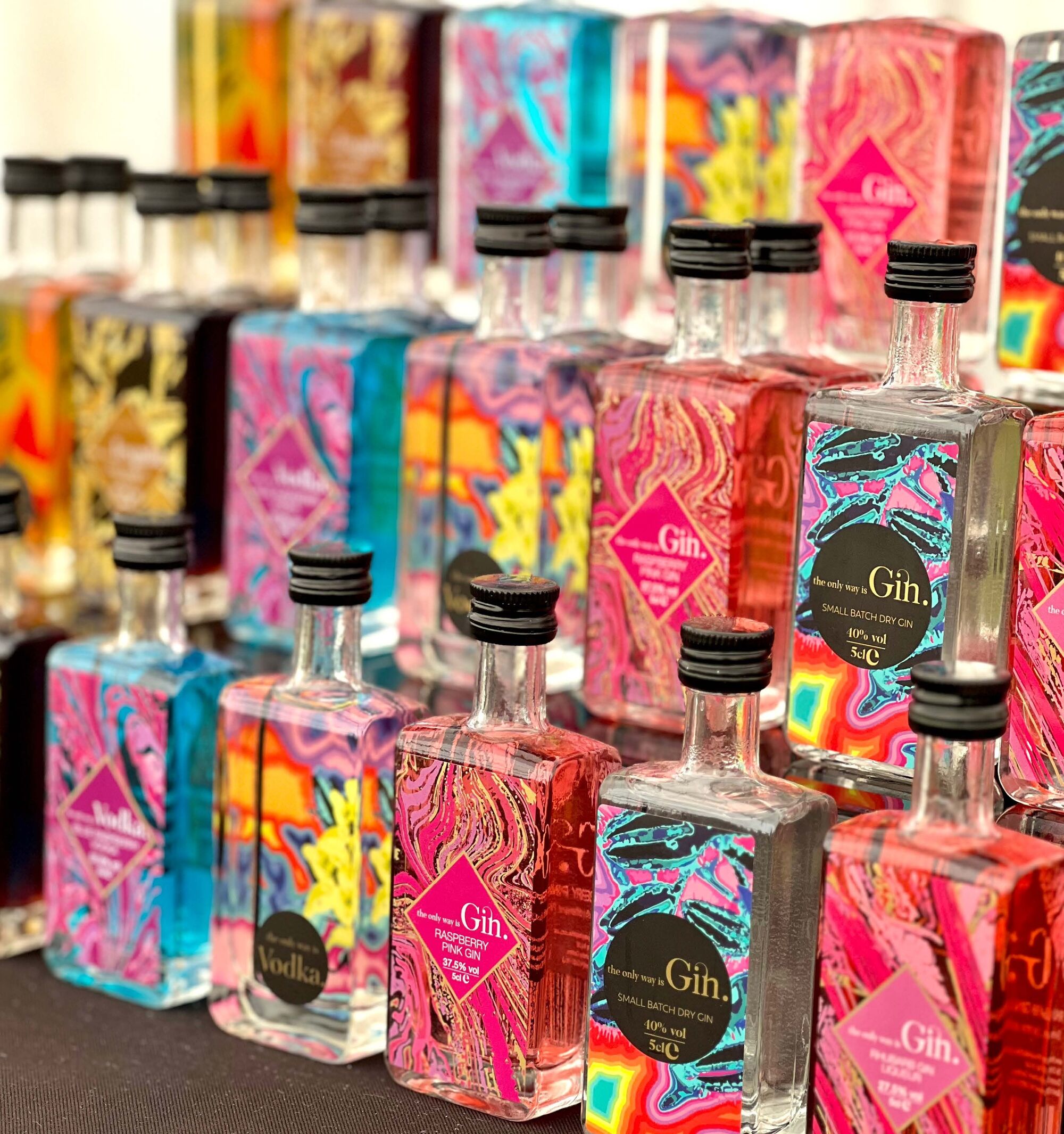 Colourful miniature bottles of gin, rum, vodka and tequila