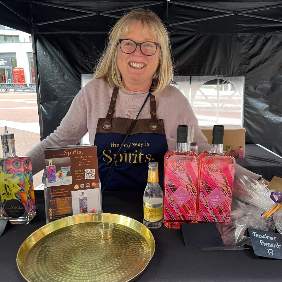 Smiling lady at a market stand